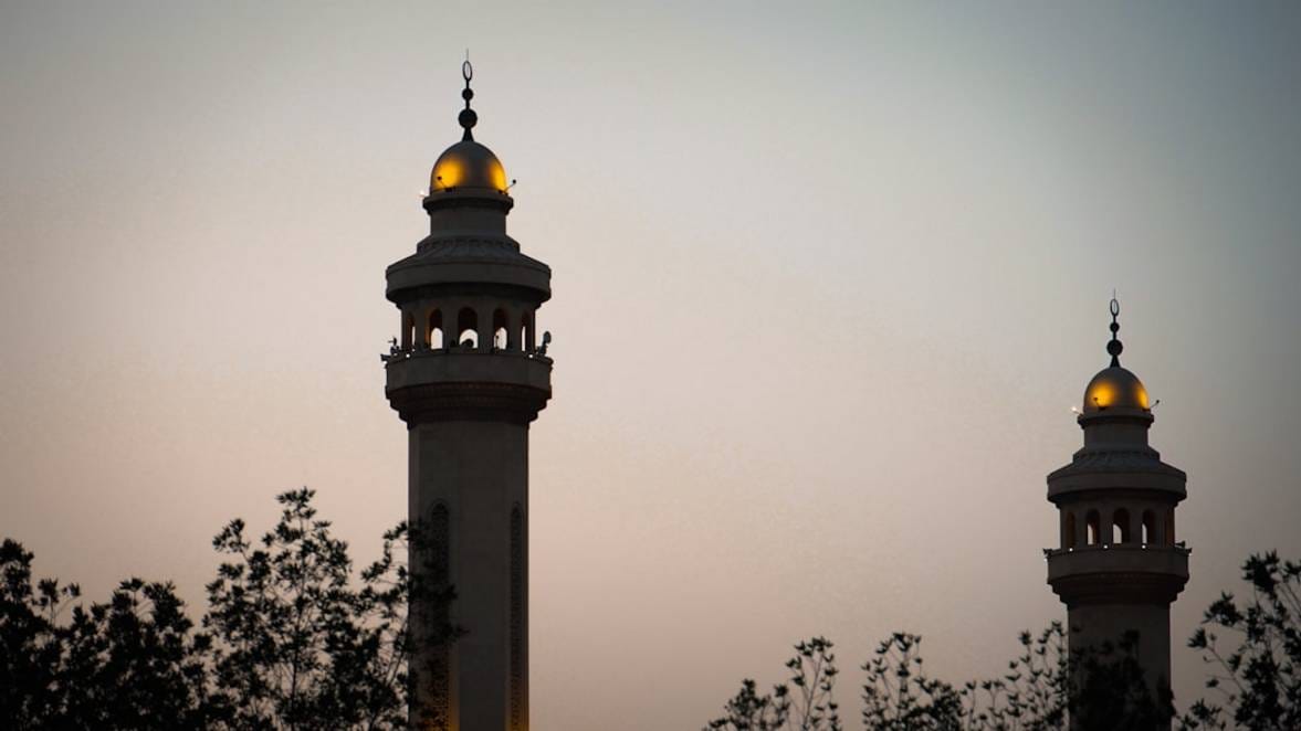 a couple of tall towers with lights on top of them xtUz1MPXmrw 2